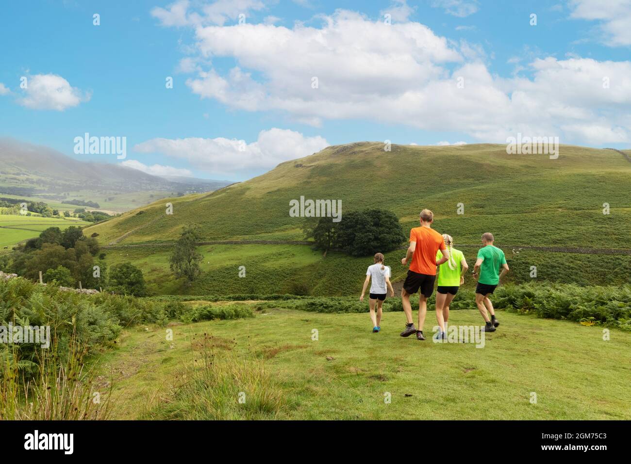 Healthy exercise outdoors; Fell runners on Walla Crag in summer, Lake District, Cumbria UK Stock Photo