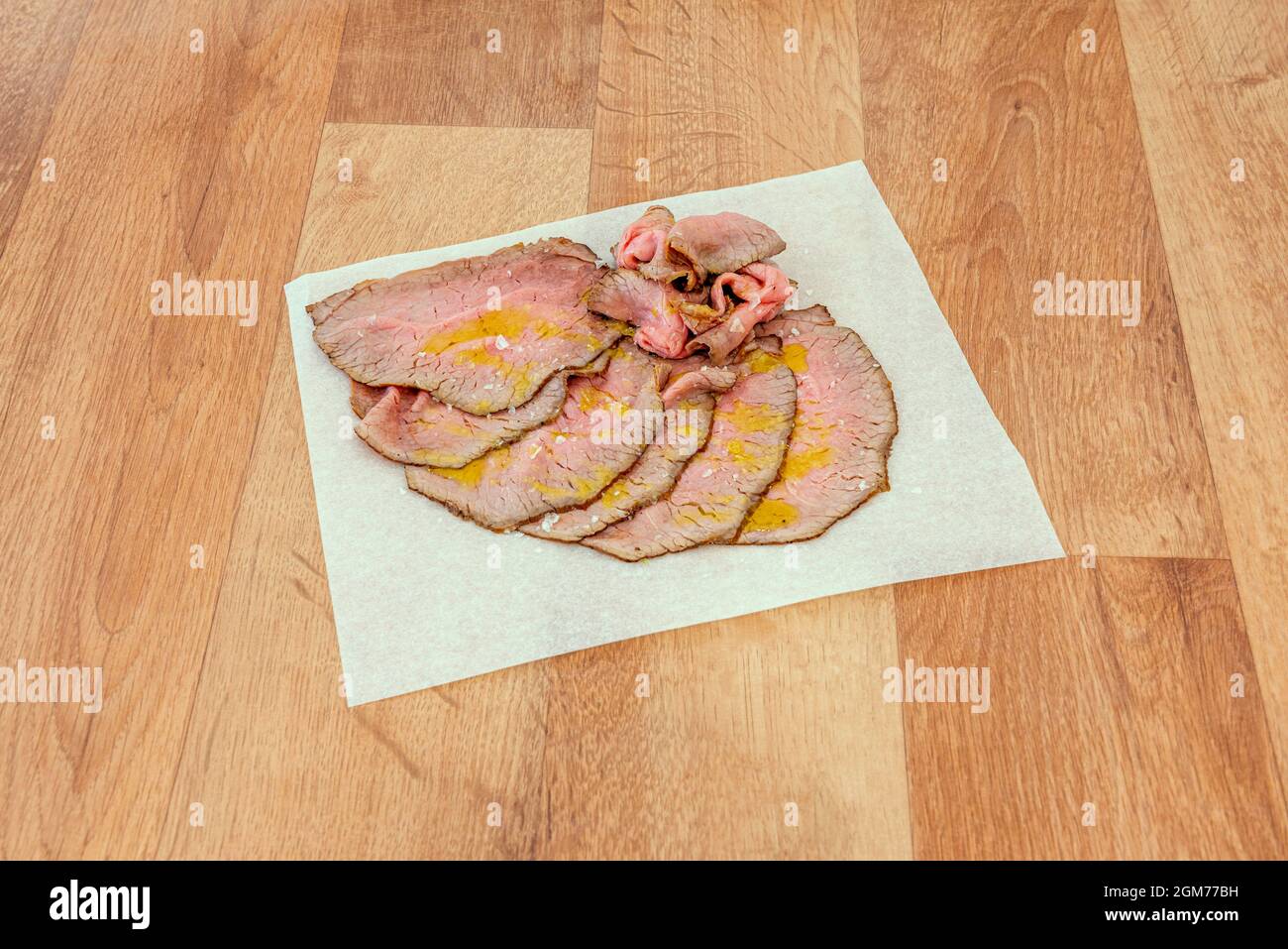 Thin slices of grassraised roast beef seasoned with olive oil and sea