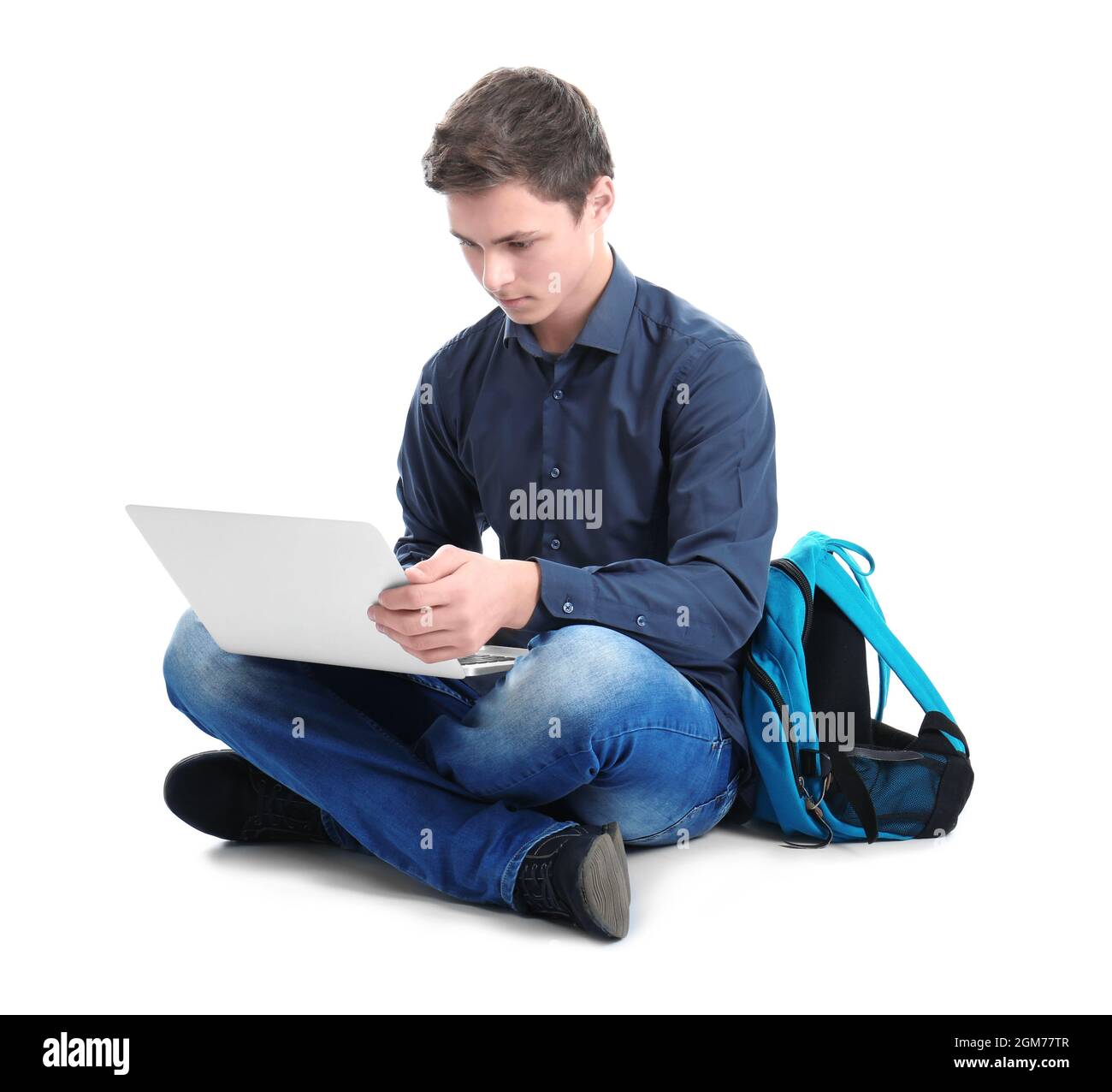 Stylish teenager using laptop against white background Stock Photo - Alamy