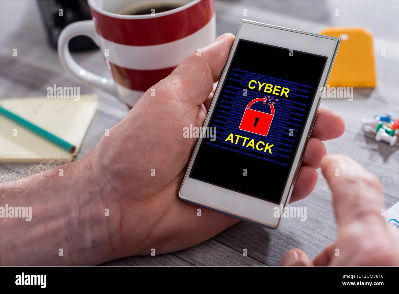 Phone Attacking Hand Male hand holding a smartphone with cyber attack concept Stock Photo ...
