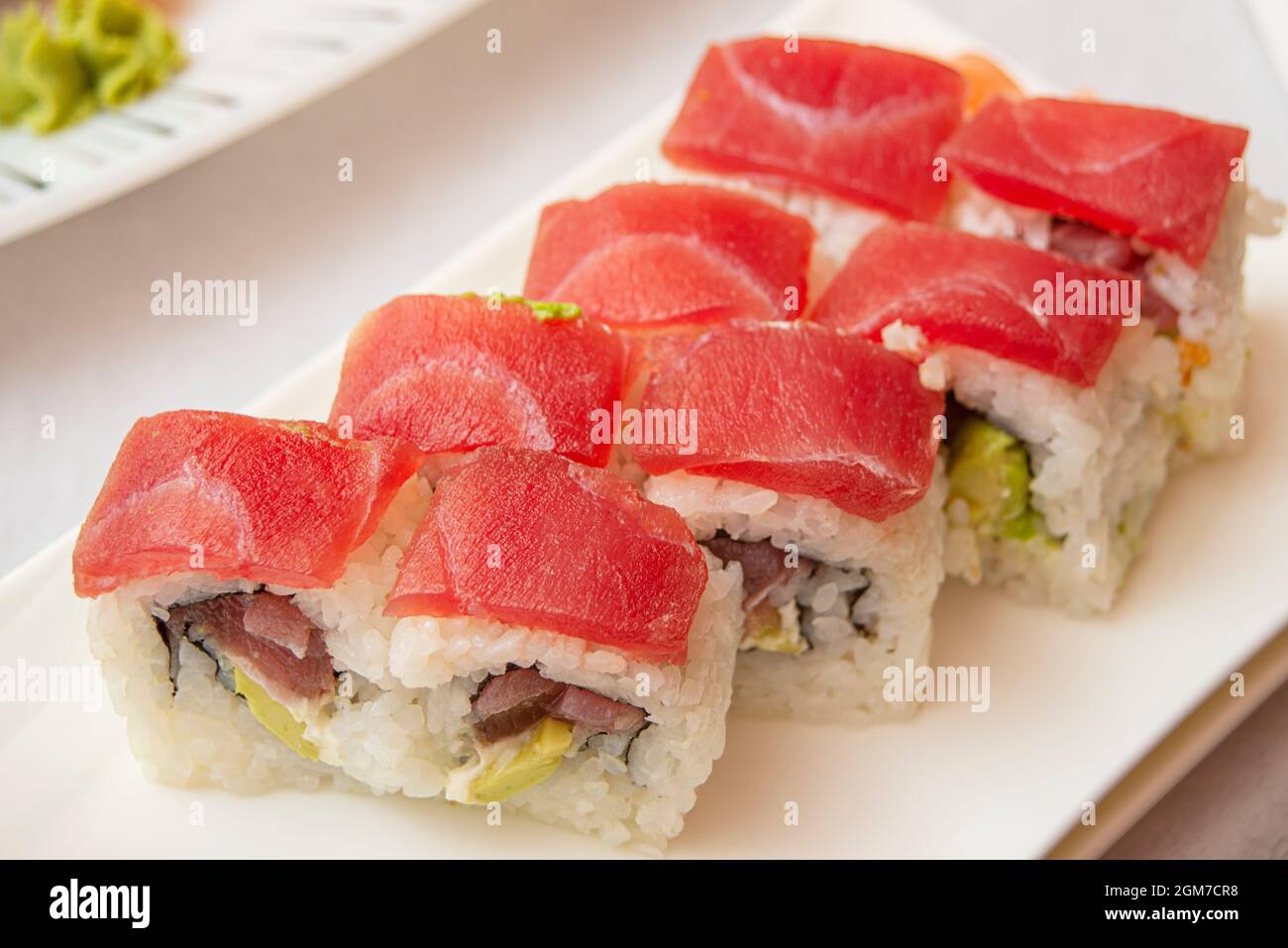 Sushi uramaki tuna roll with avocado, nori seaweed, cream cheese and