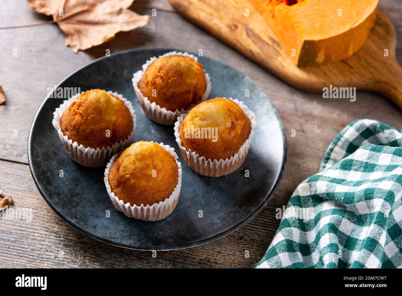 Pumpkin muffins on wooden table Stock Photo