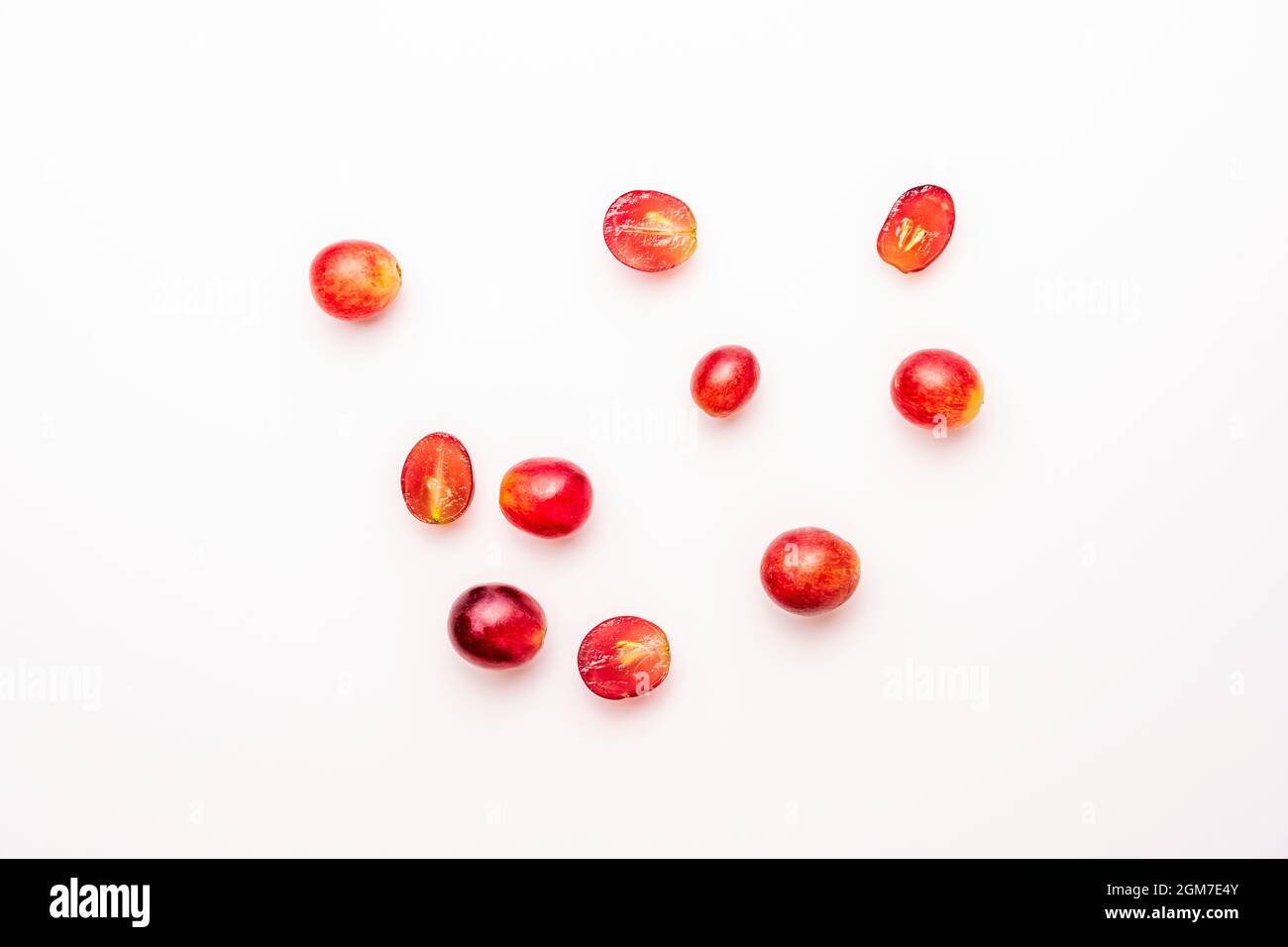 top view image of some claret red dessert grapes on white table Stock Photo