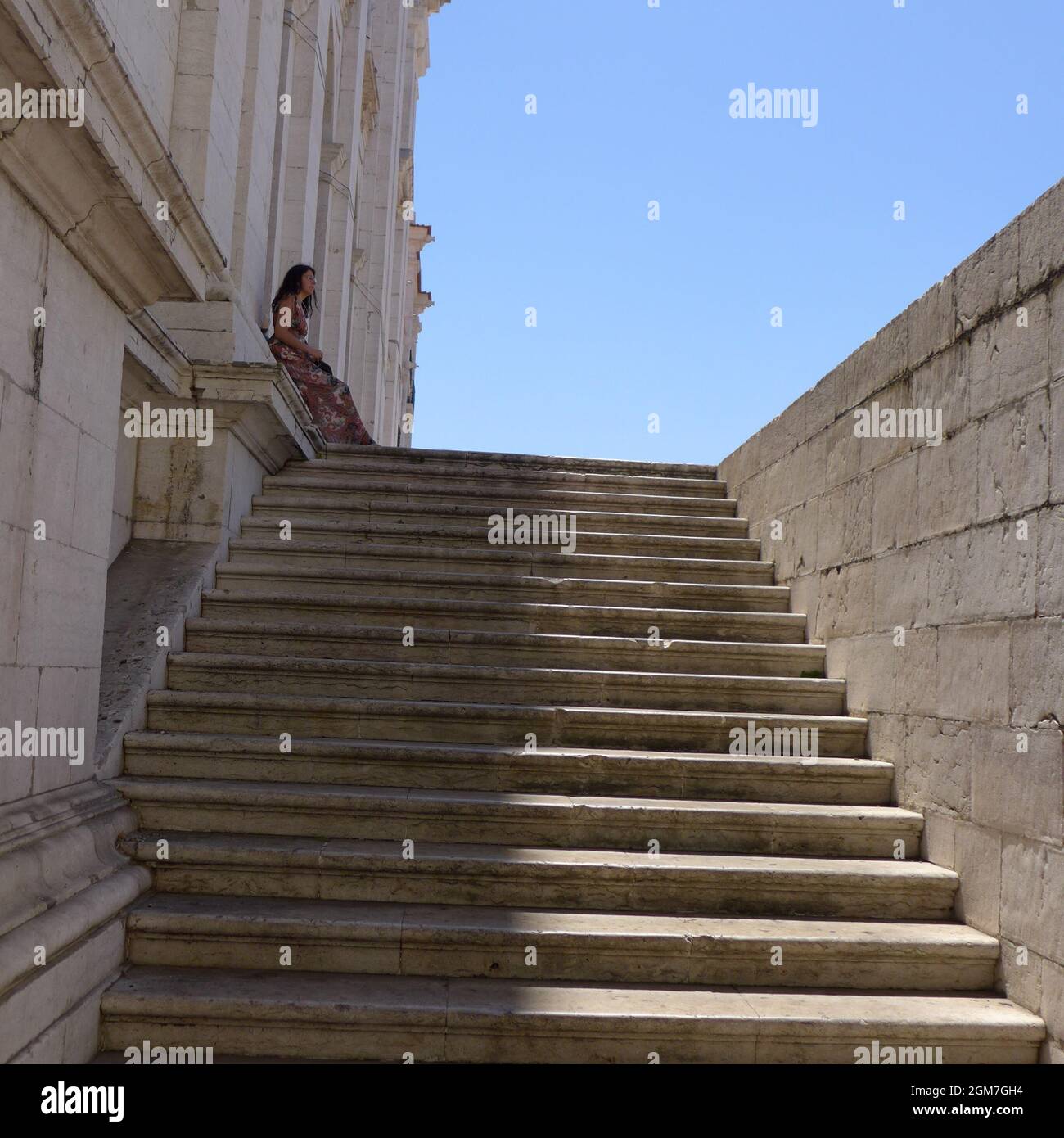 Steps in Lisbon Portugal with a woman on top during summer Stock Photo