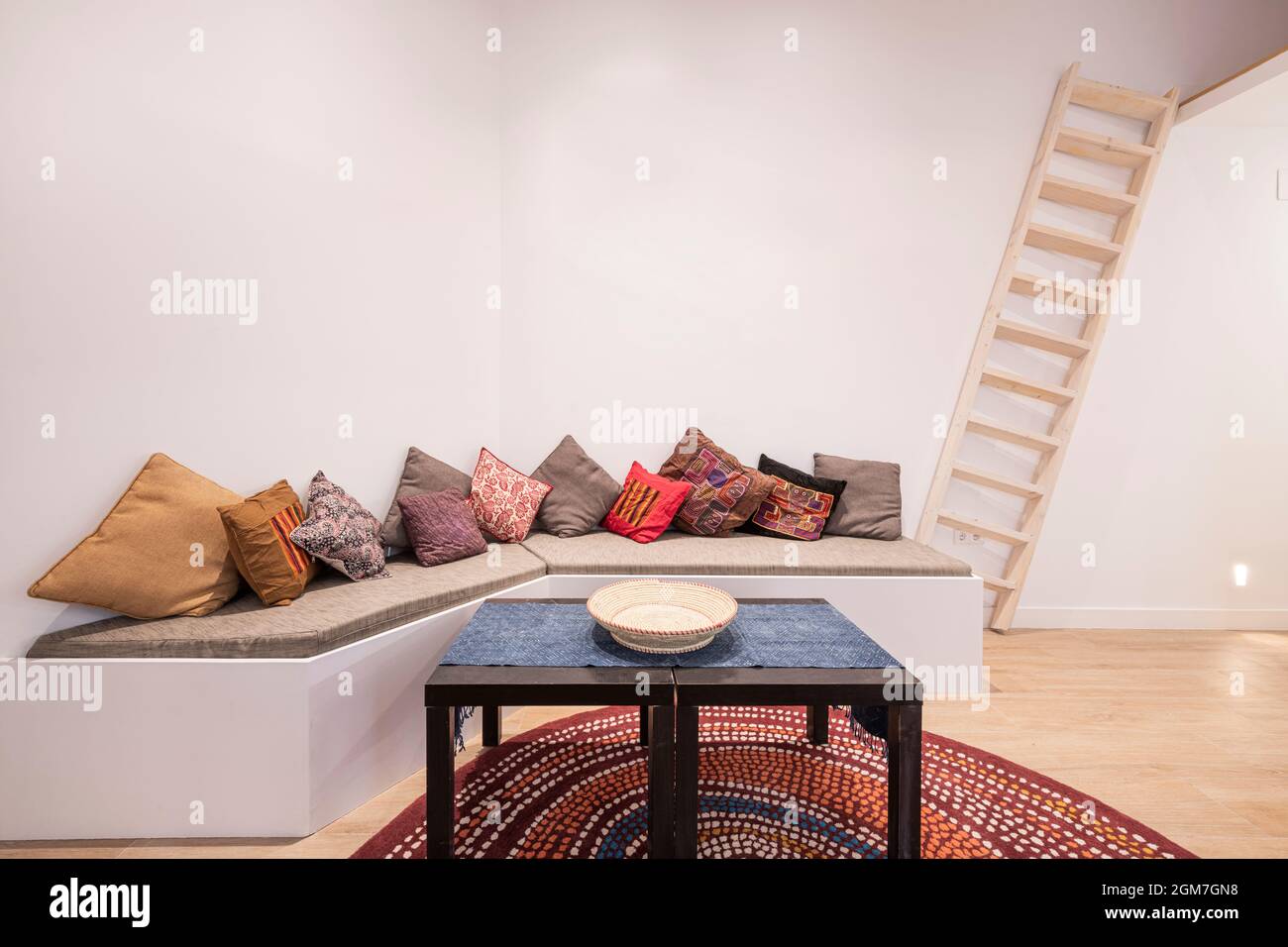 Living room decorated in Moroccan style with a long-cushioned sofa and many  cushions Stock Photo - Alamy, image size:1300x956