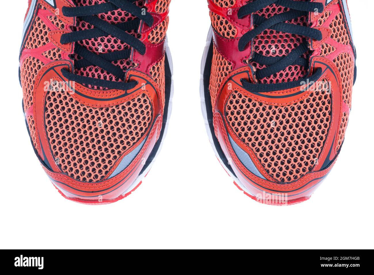 Red running shoes with black laces on a white background Stock Photo