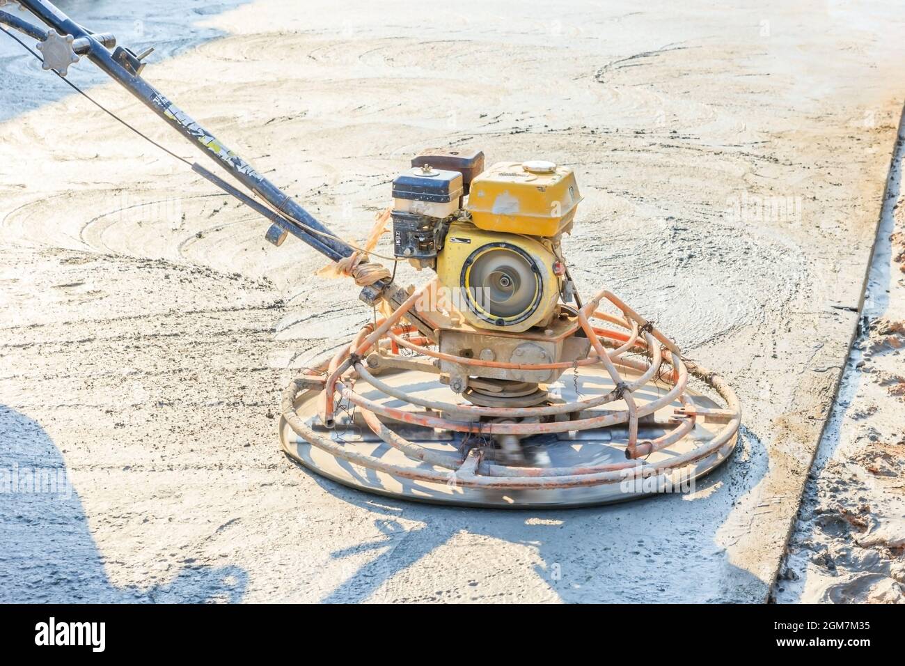 Construction worker produces the grout and finish wet concrete with a