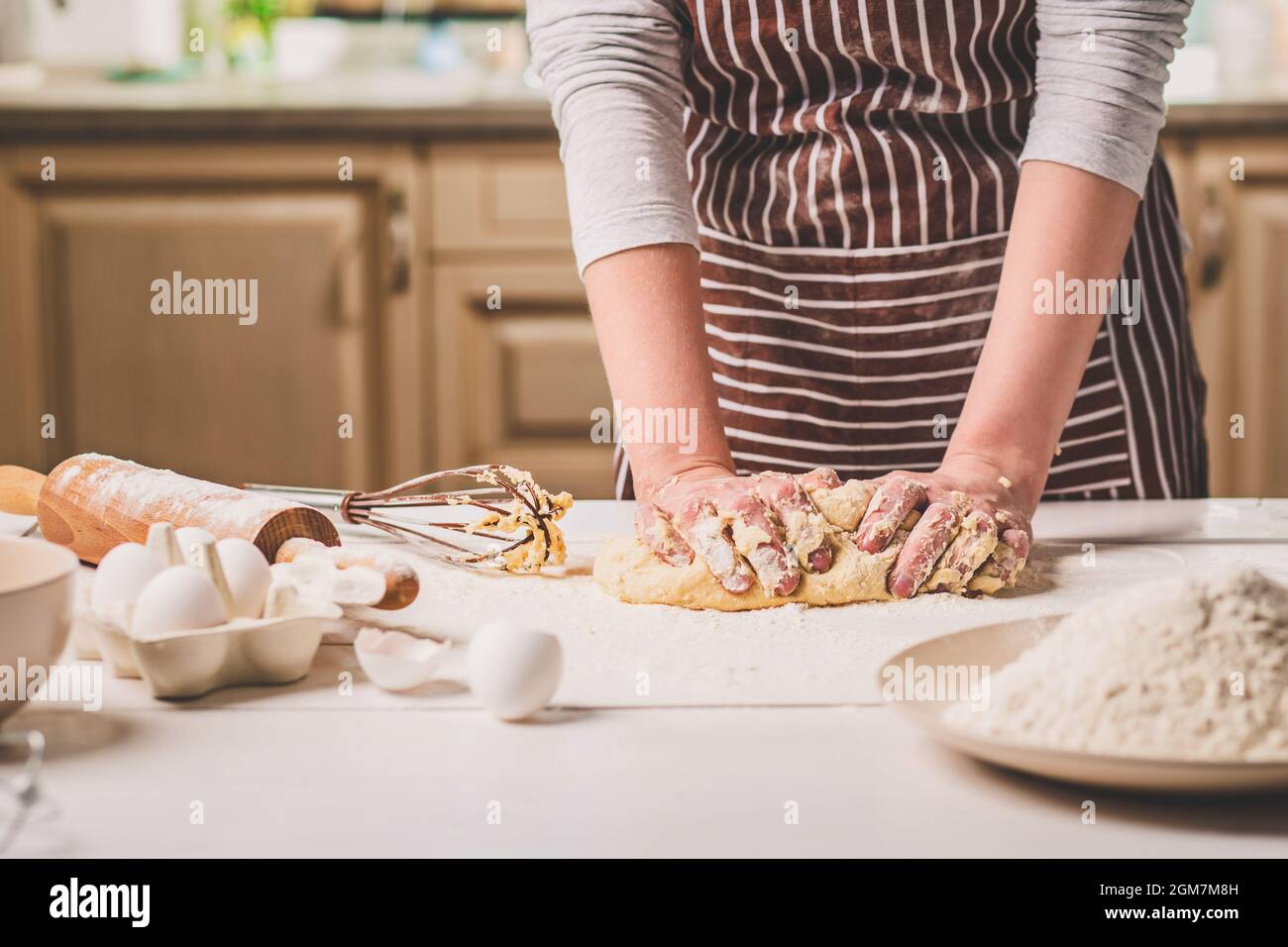 Woman hands kneading dough on kitchen table Stock Photo - Alamy