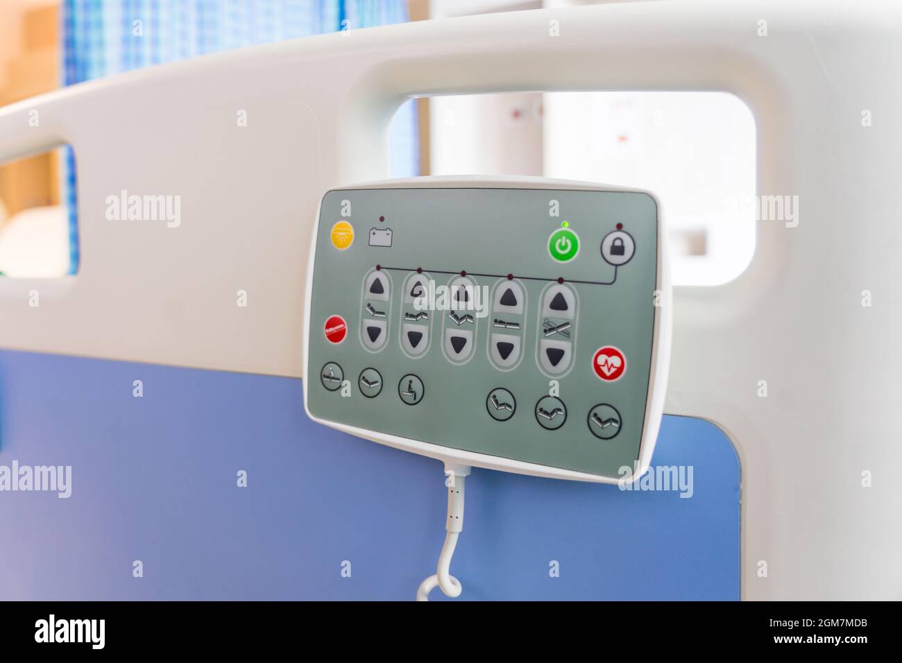 Hospital bed remote control hanging on the bed rail. technology of