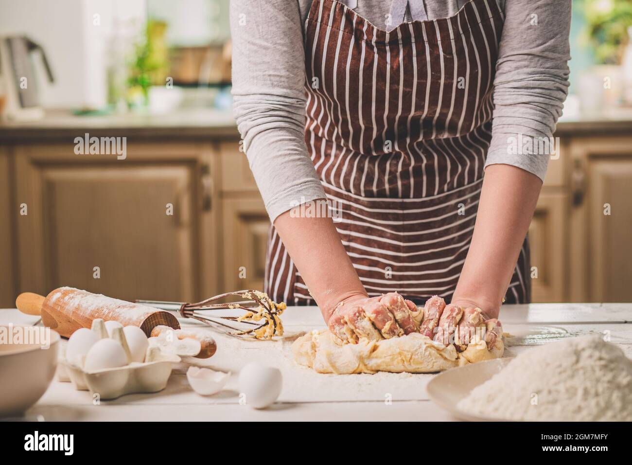 Woman hands kneading dough on kitchen table Stock Photo - Alamy