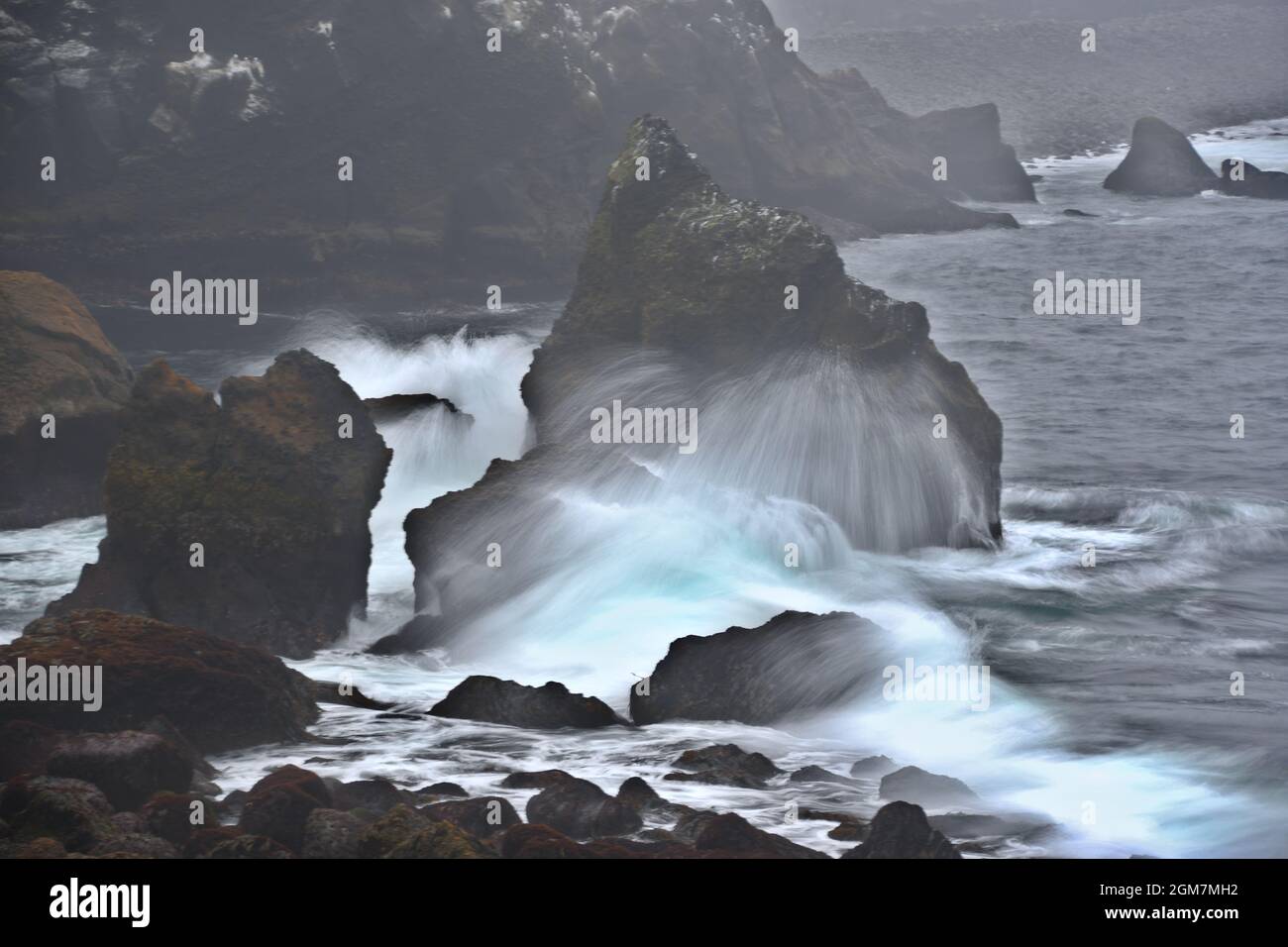 Long exposure of waves hitting a rock on the Reykjanes peninsula Stock Photo