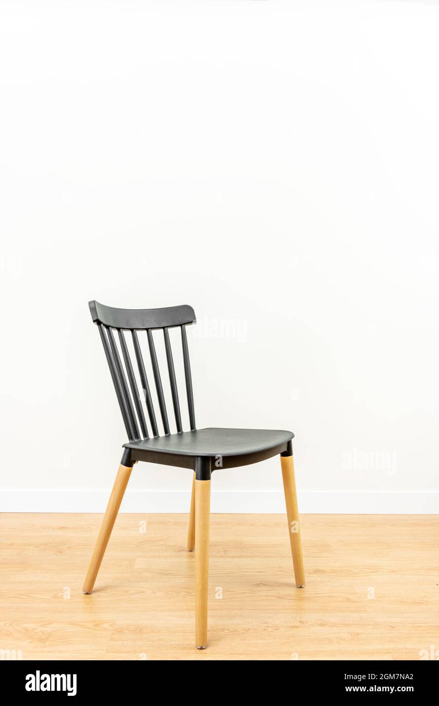 lonely black chair with colorless varnished beech wood legs in white ...