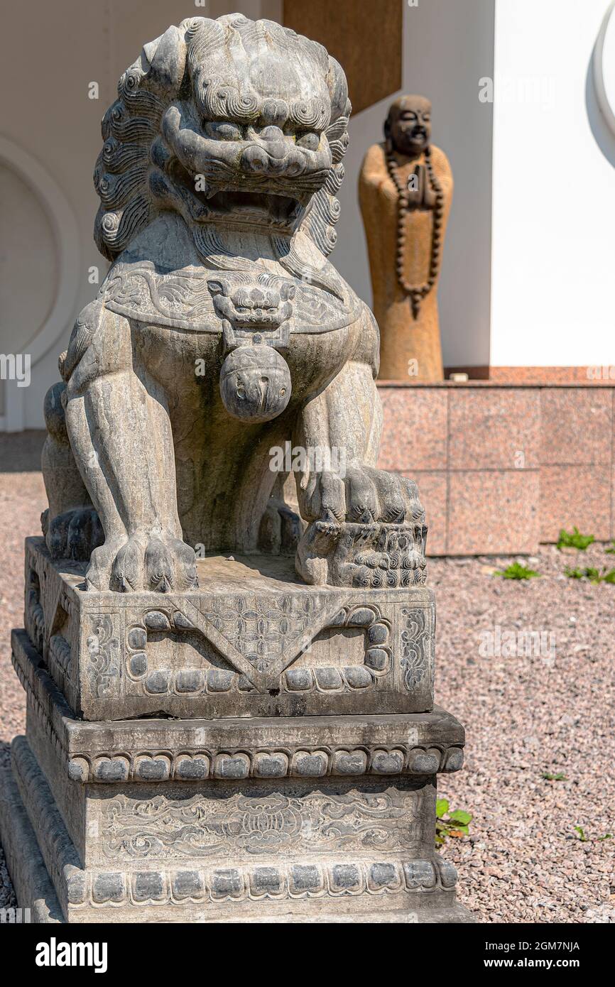 JÖNSTORP, SWEDEN - JULY 18, 2021: A statue of a sitting Chinese Lion at the yangtorp sanctuary in Skåne. Stock Photo