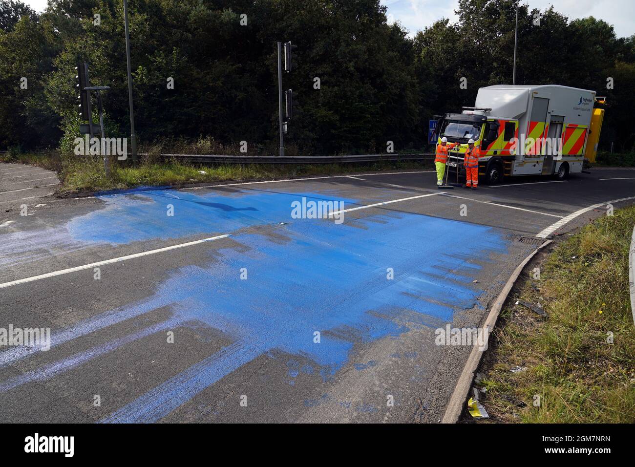 Highways England workers on the exit slip road of the M25 motorway near