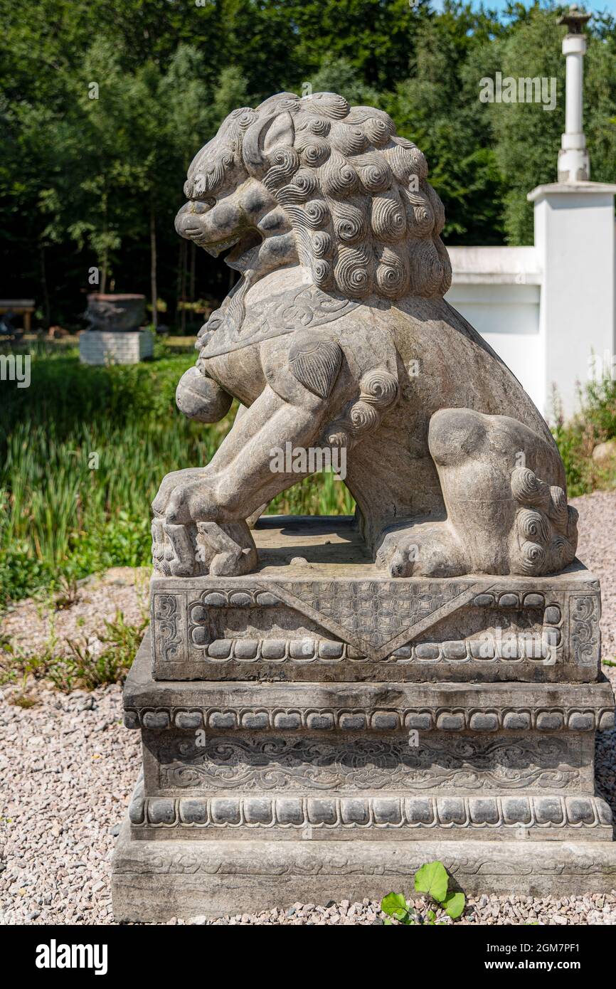 JÖNSTORP, SWEDEN - JULY 18, 2021: A statue of a sitting Chinese Lion at the yangtorp sanctuary in Skåne. Stock Photo