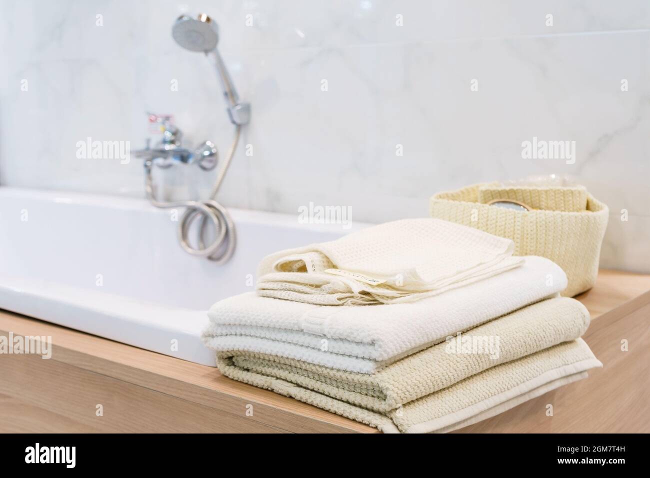 White towel lies on bathtab in bathroom in the background Stock Photo