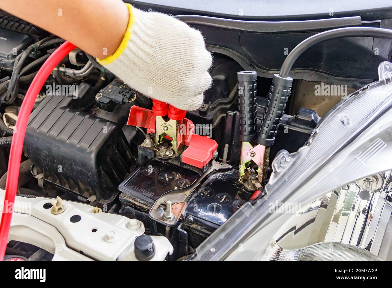 Charging car battery with electricity trough jumper cables,red and