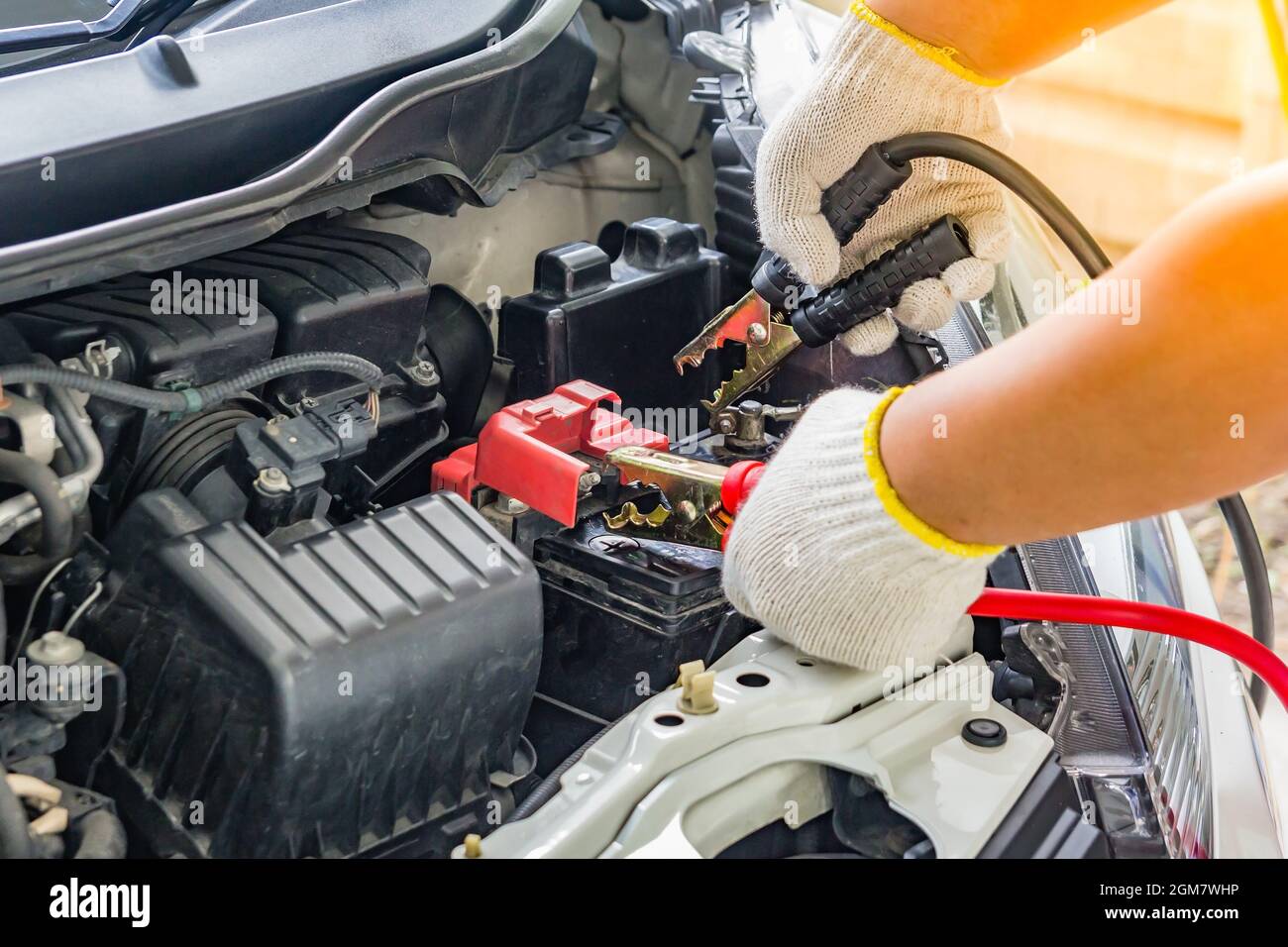 Charging car battery with electricity trough jumper cables,red and