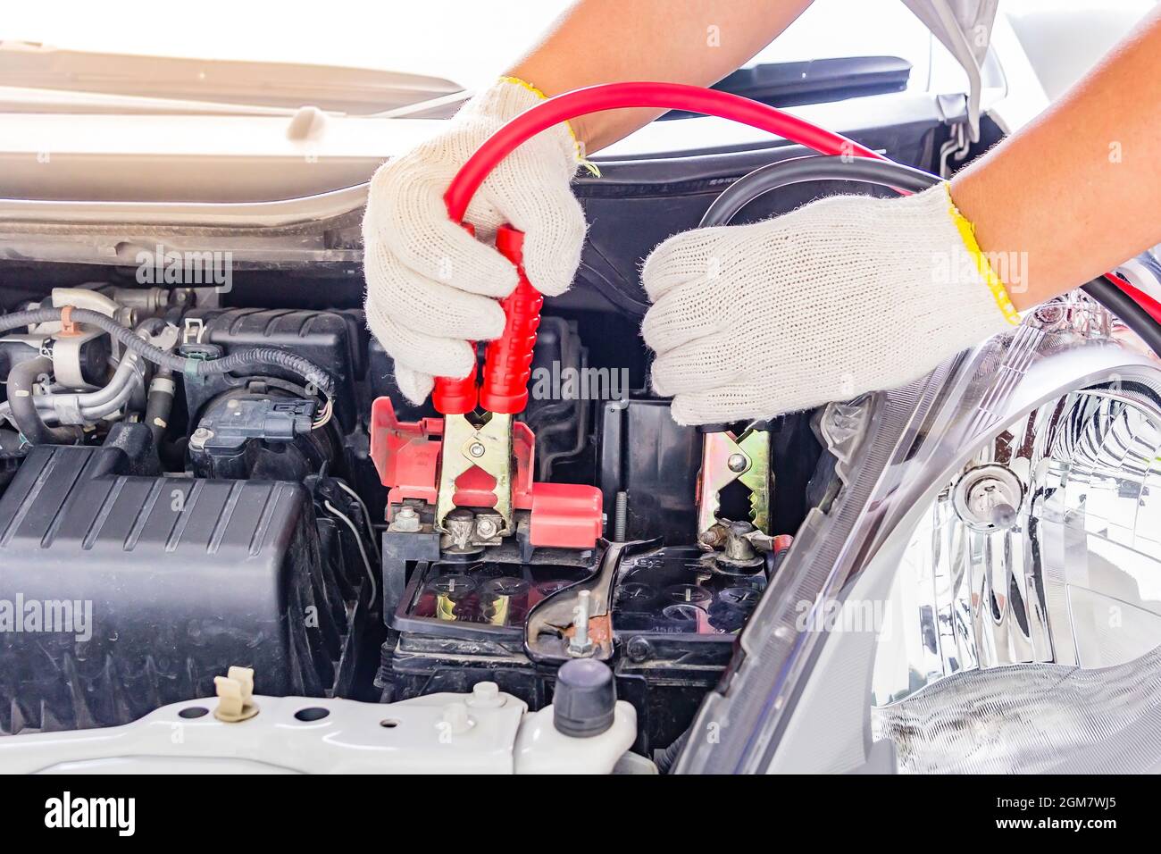 Charging car battery with electricity trough jumper cables,red and