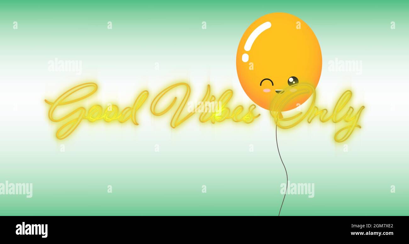 Image of the words good vibes in flickering yellow neon with orange balloon on green and white Stock Photo