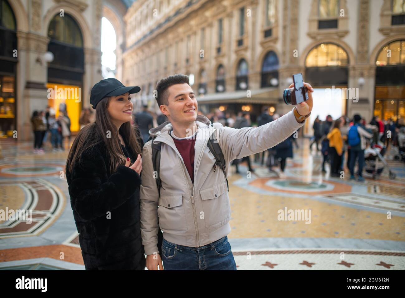 Couple of turists taking a selfie in the city of Milan, Italy Stock Photo