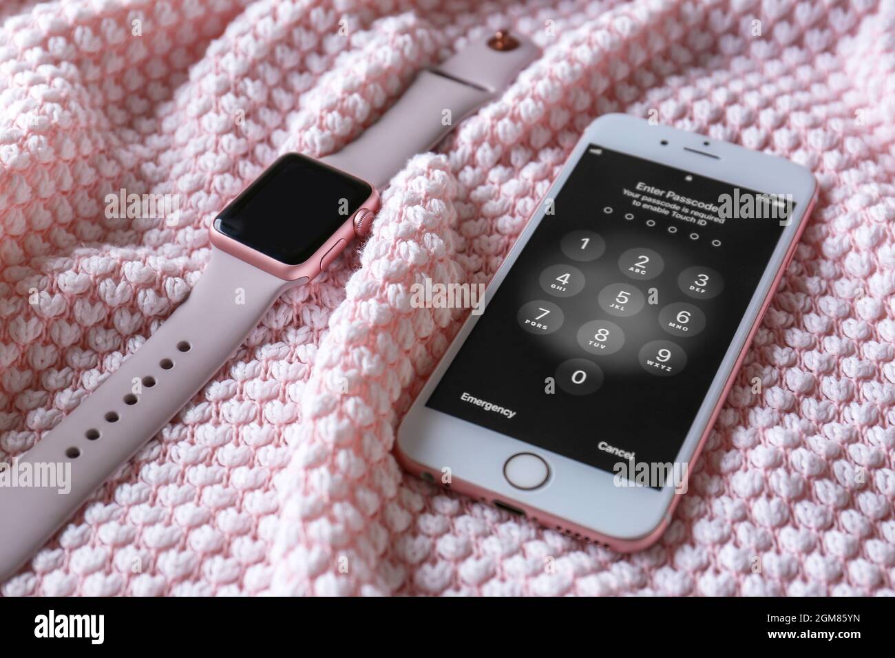 KYIV, UKRAINE - NOVEMBER 28, 2017: Modern iPhone 6s Plus Rose Gold  displaying numpad for entering the passcode and Apple Watch on fabric Stock  Photo - Alamy