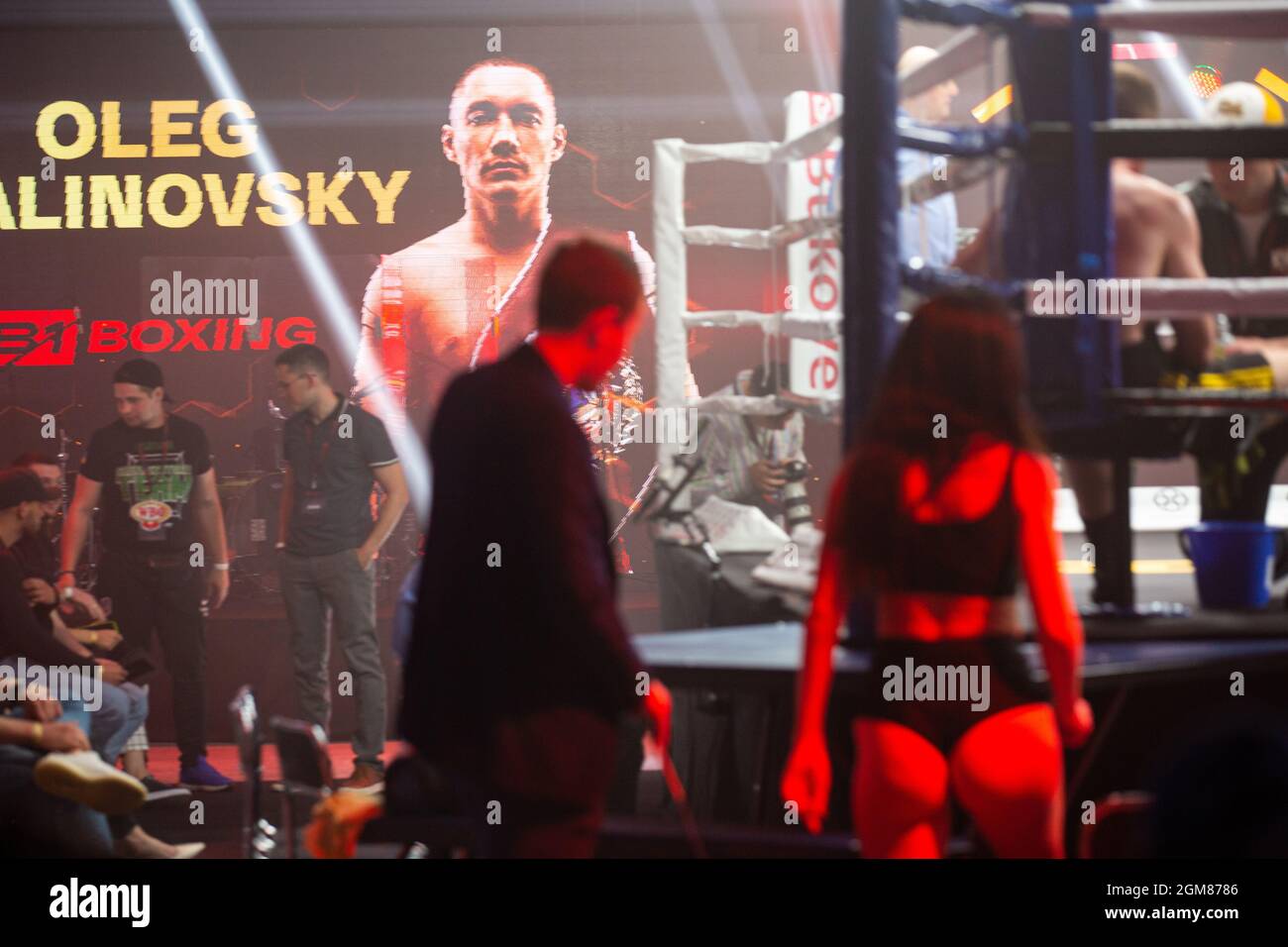 Busy B1Boxing night: Oleg Malinovsky Interconti belt, pretty ring card girls impress public in attendance, fighters in ring, promoters are watching. Stock Photo