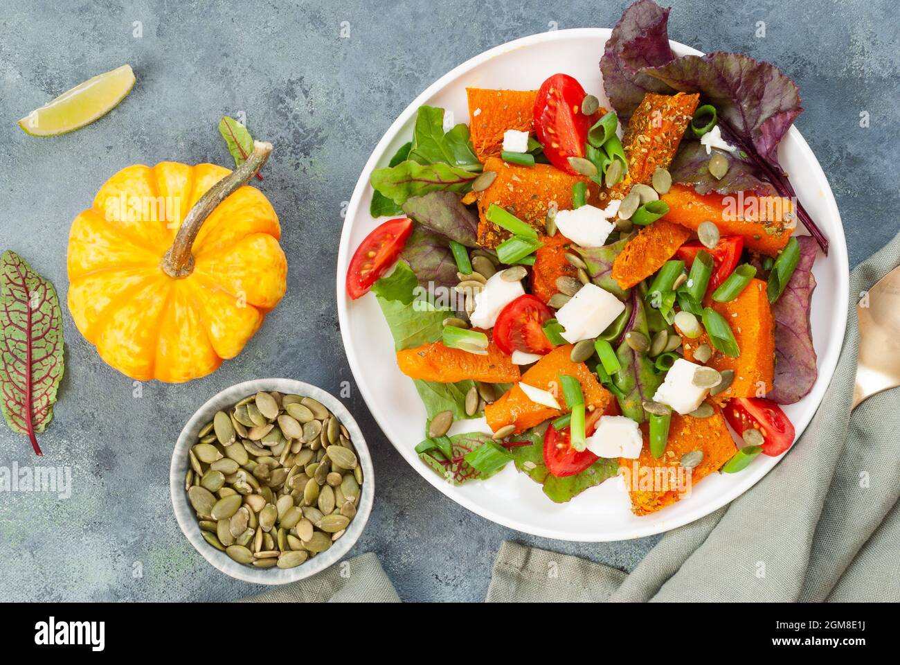Pumpkin salad with cheese, tomatoes and pumpkin seeds Stock Photo