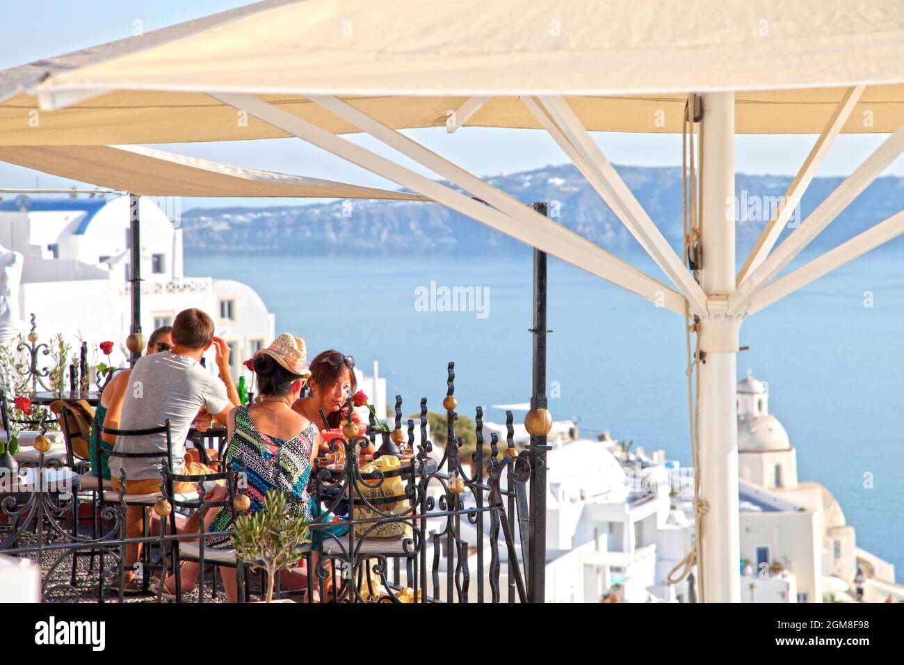 A view of the sea from PK Cocktail Bar with people in Fira, Santorini, Greek Islands, Greece
