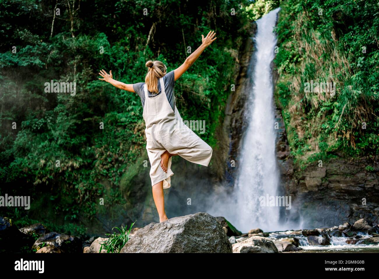 Woman yoga in front waterfall hi-res stock photography and images - Alamy