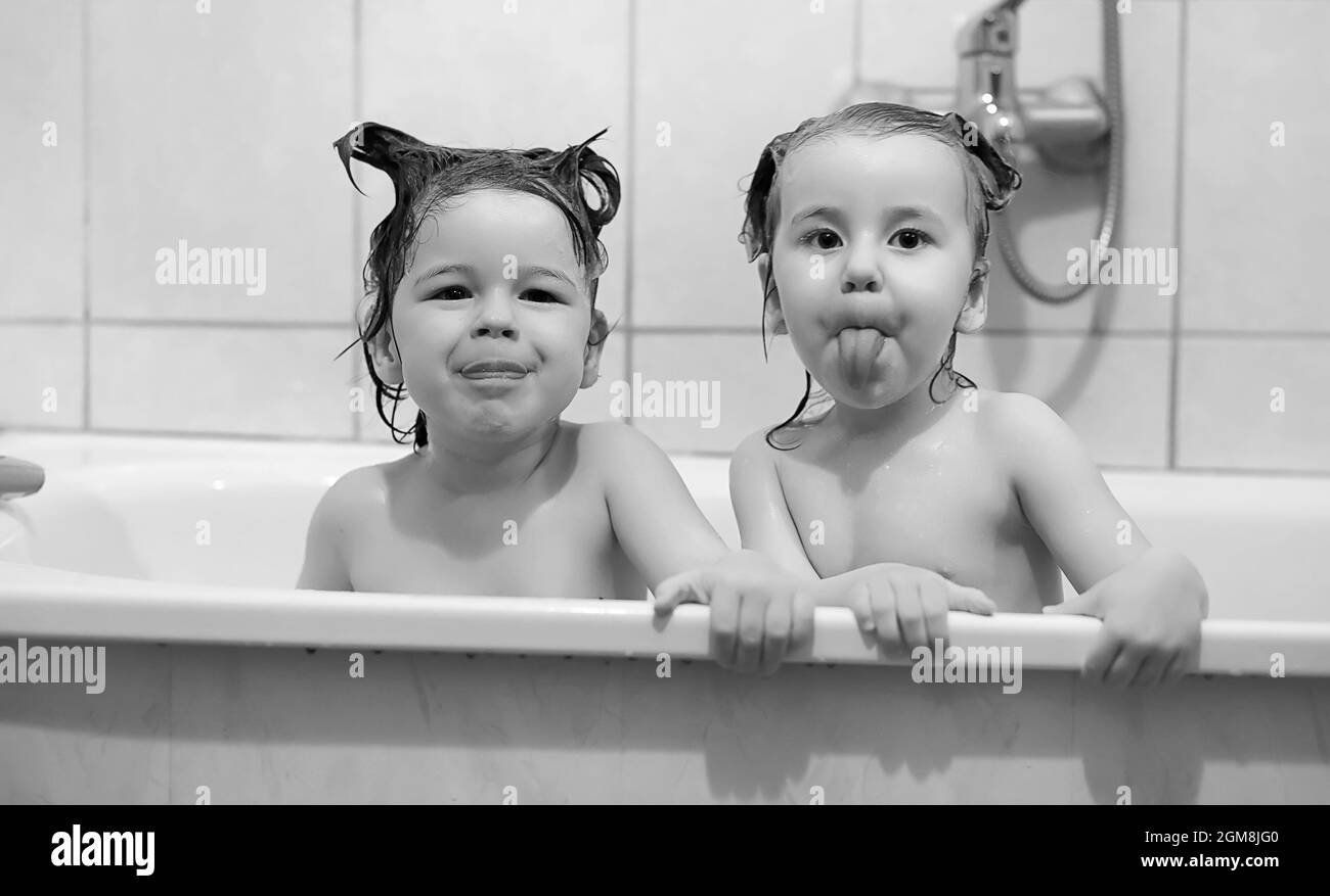 Young children take a bath. Children wash in bathroom. Brother and