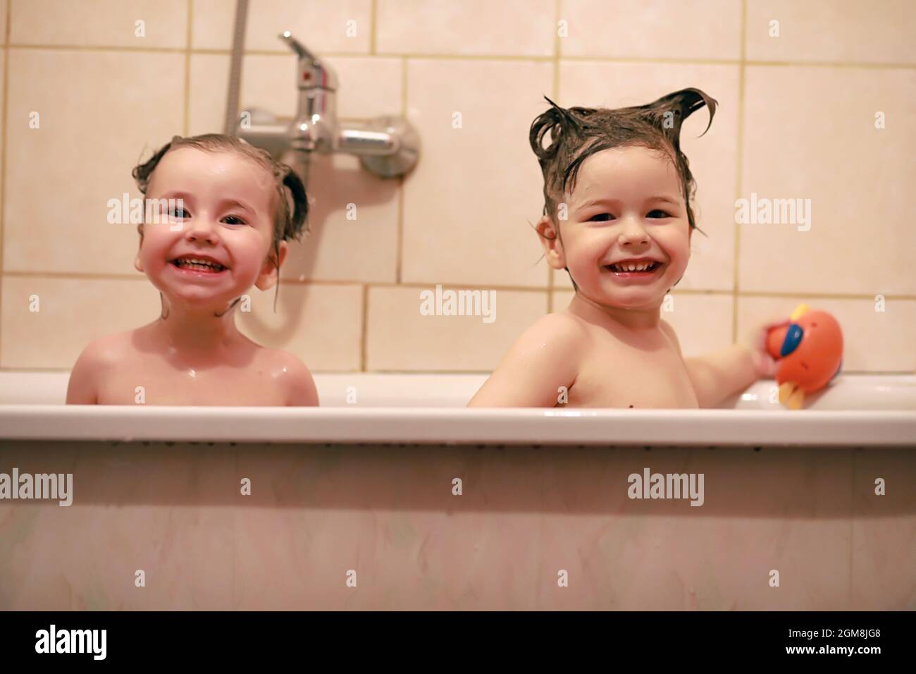 Young children take a bath. Children wash in bathroom. Brother and