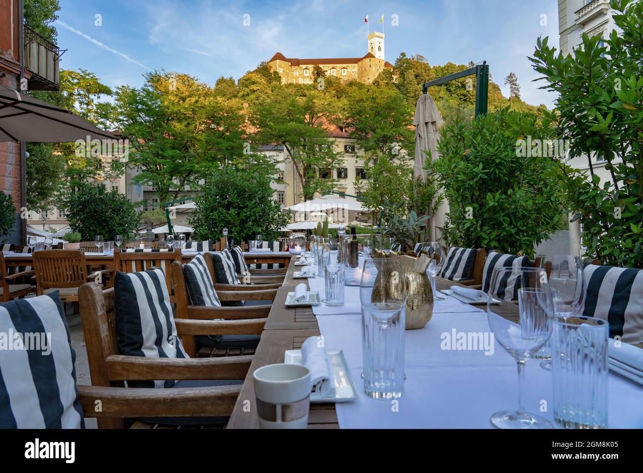 All set table waiting for guests in a restaurant in Ljubljana with a nice view of the castle Stock Photo