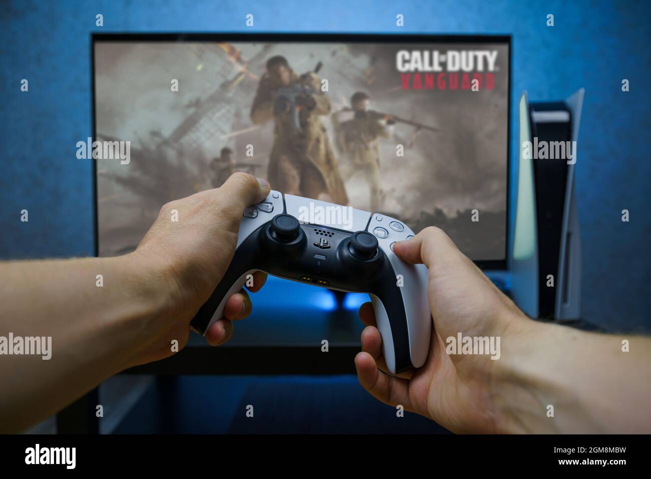 Call of Duty: Vanguard is first-person shooter video game. Man playing video game with Playstation 5 Stock Photo