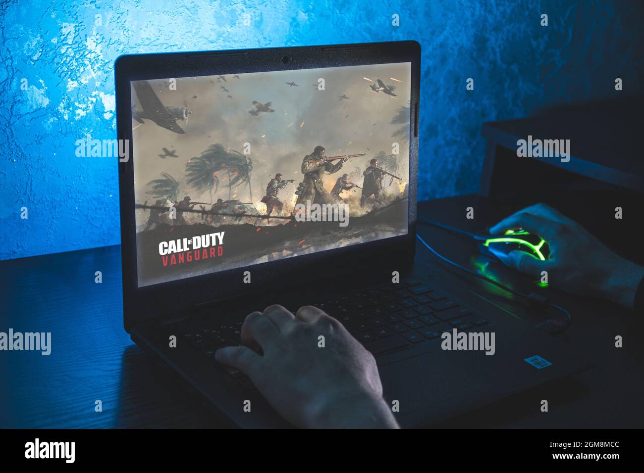 Call of Duty: Vanguard is first-person shooter video game. Man playing video game on laptop Stock Photo