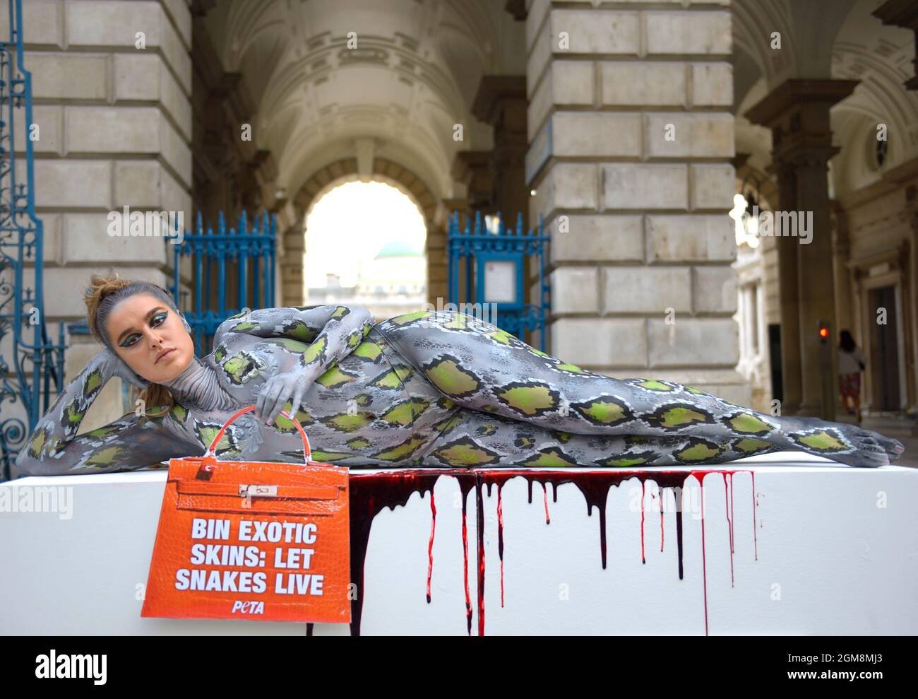 London, UK. 17th Sep, 2021. TOWIE star Chloe Ross poses in reptile body paint outside Somerset House on the second day of London Fashion Week as part of a PETA campaign to draw attention to the use of exotic skins in the fashion industry Credit: Phil Robinson/Alamy Live News Stock Photo