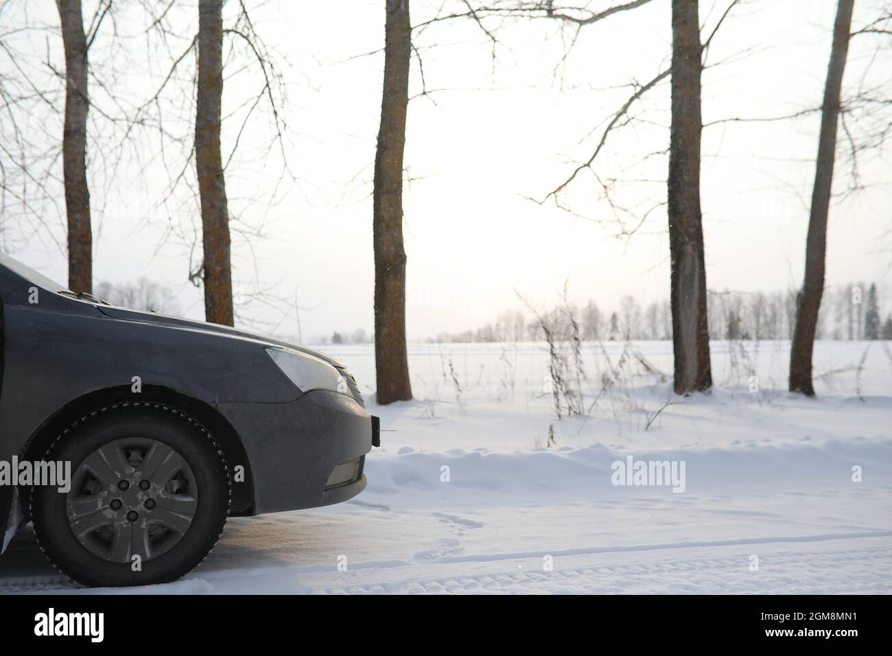 Car on a snowy winter road in the fields Stock Photo - Alamy