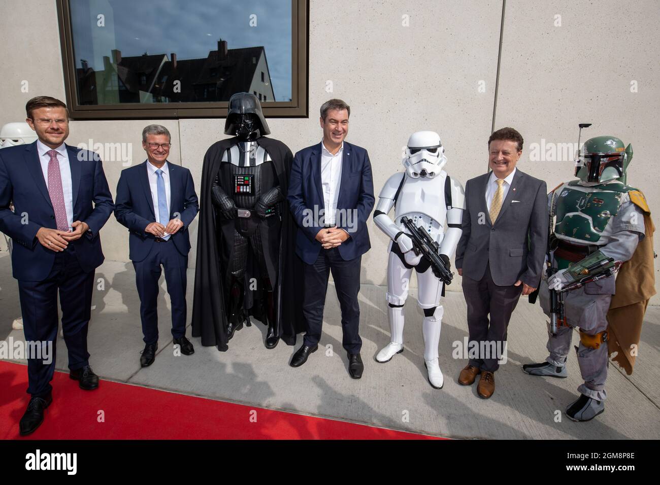 17 September 2021, Bavaria, Nuremberg: Nuremberg Mayor Marcus König (CSU, l-r), Bernd Sibler (CSU), Bavarian State Minister for Science and the Arts, Markus Söder, CSU Party Chairman and Minister President of Bavaria, and Wolfgang Heckl, Director General of the Deutsches Museum, stand between actors dressed as characters from the film 'Star Wars' at the opening of the new branch of the Deutsches Museum Nuremberg. The museum presents future topics and discusses ethical questions. According to its own information, it is one of four future museums worldwide. Photo: Daniel Karmann/dpa Stock Photo