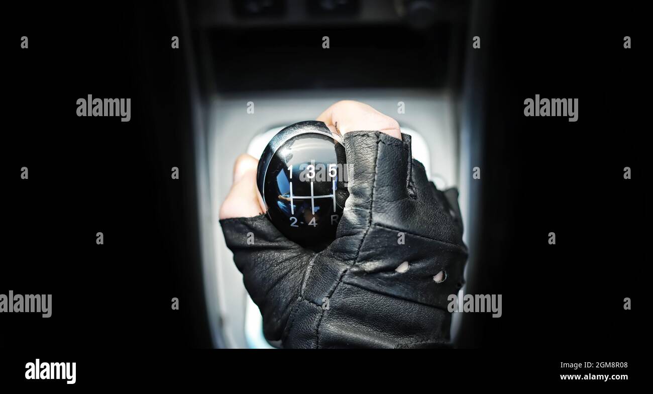Gear lever. Manual Transmission. Hand on the gear shift in a car Stock ...