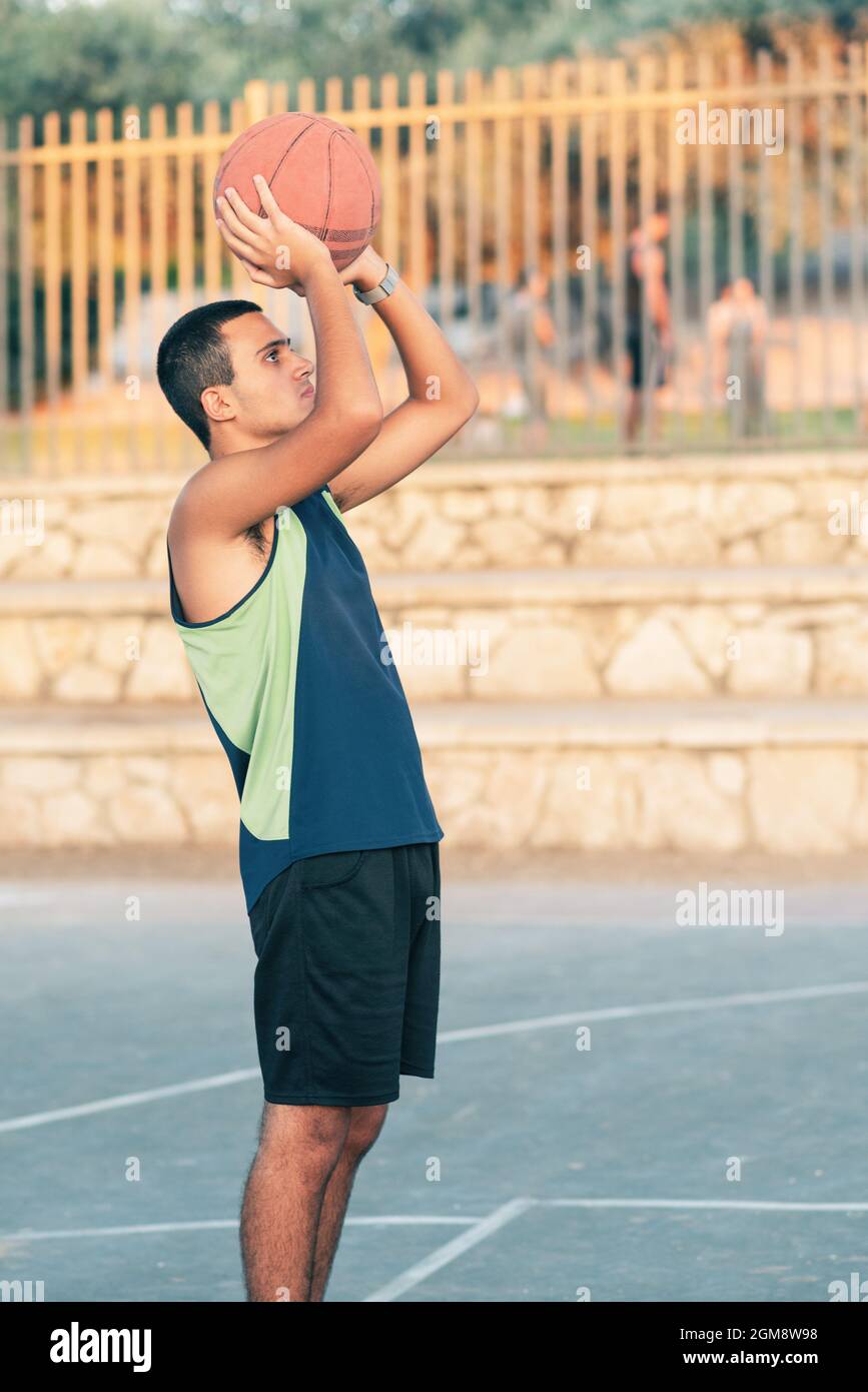 Happy Teen Playing On Basketball Court With Basket Ball. Young Child
