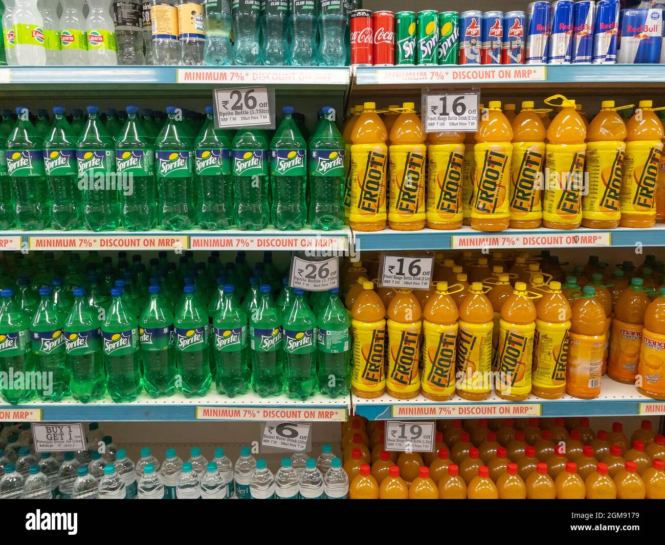 Carbonated soft drinks and juices displayed on the shelves of a supermarket in Pune India on 8 November 2021 Stock Photo