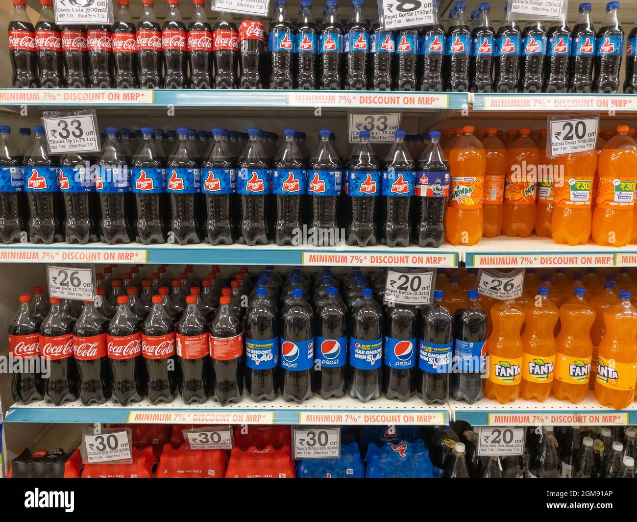 Carbonated soft drinks and juices displayed on the shelves of a