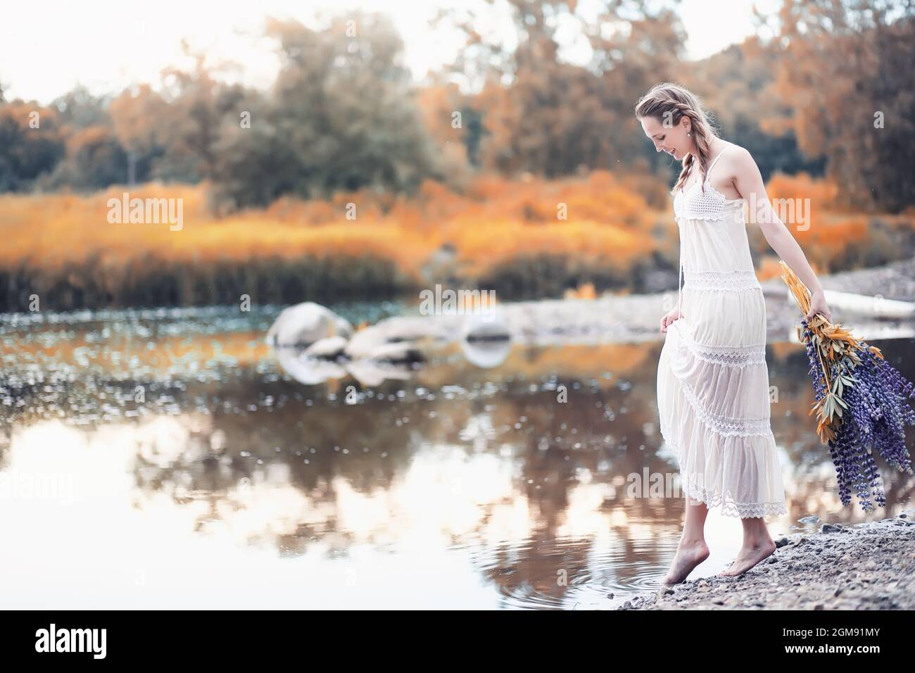 Beautiful girl with a bouquet of blue flowers on nature in autumn Stock ...