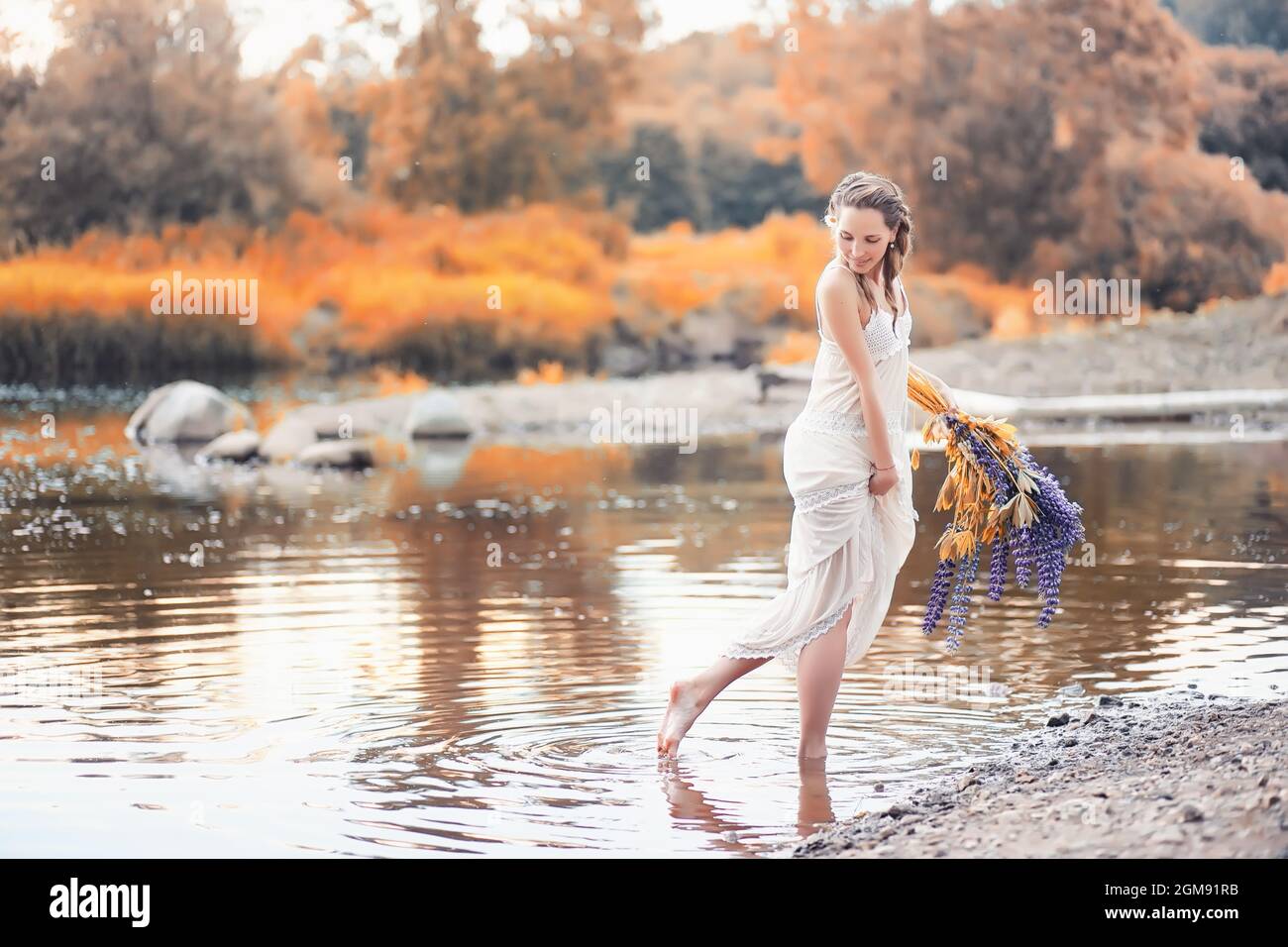 Beautiful girl with a bouquet of blue flowers on nature in autumn Stock ...
