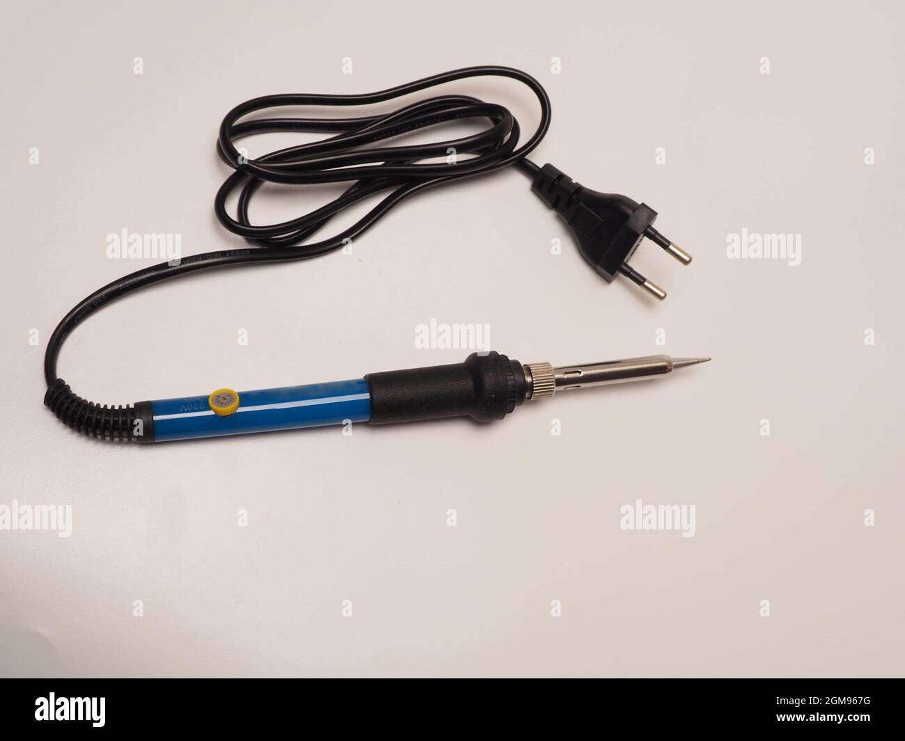 Close up shoot of soldering iron, a tool for soldering electrical components. Shoot on white isolated background Stock Photo