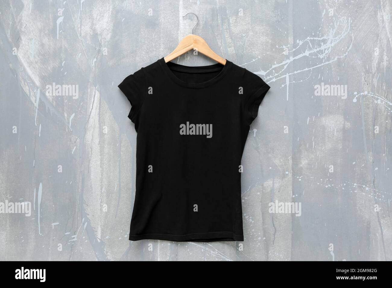 Black t-shirt on grunge background. Mockup for design Stock Photo - Alamy