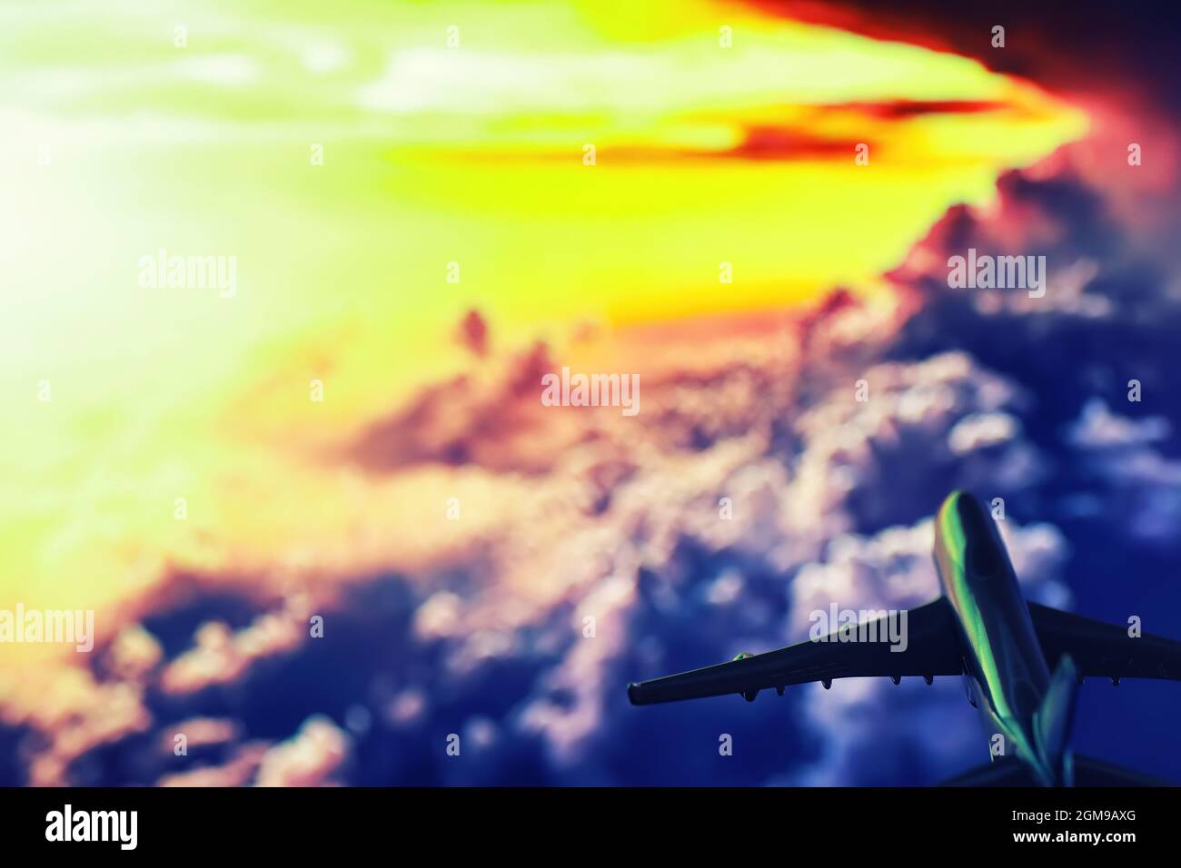 The travel by plane flies in the sky above the clouds Stock Photo - Alamy