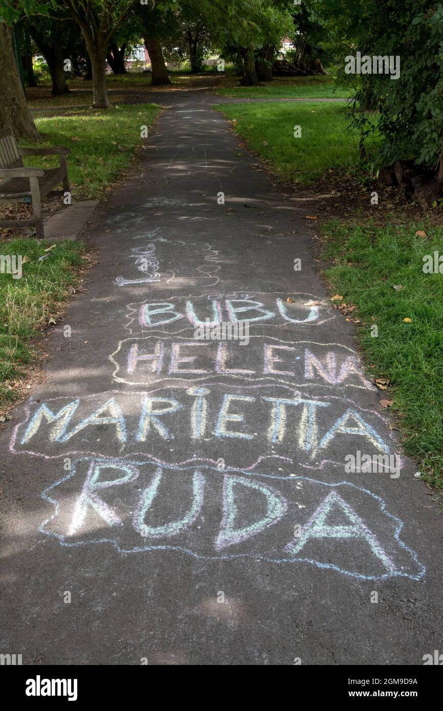 Children's first names chalked on to a pavement in a park, Bubu, Helena, Marietta and Ruda. The changing face of Britain. 2021 2020s London HOMER SYKES Stock Photo