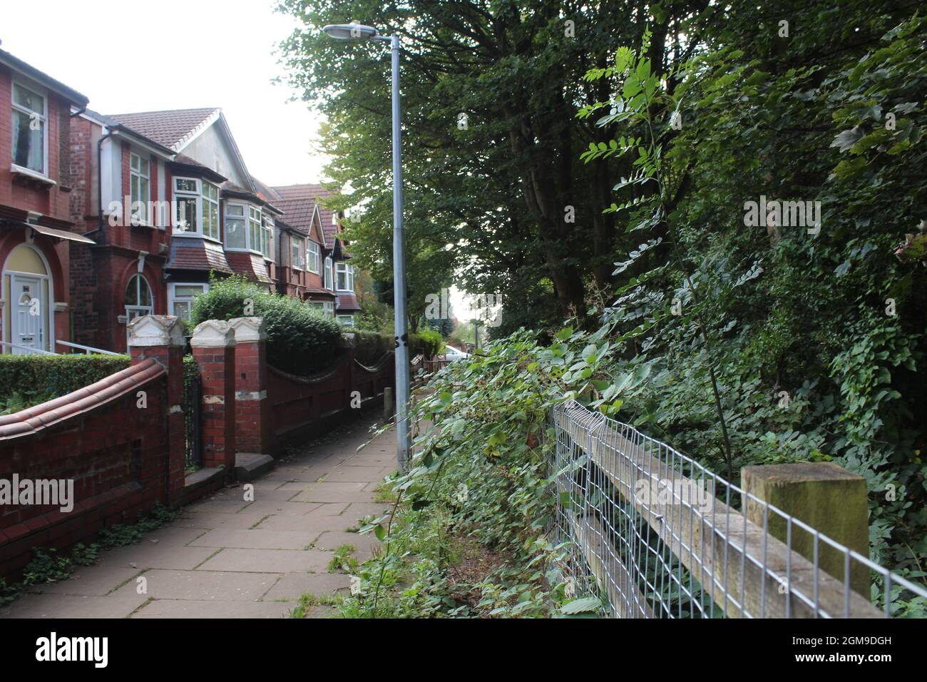 A path beside houses in Higher Broughton, England Stock Photo Alamy
