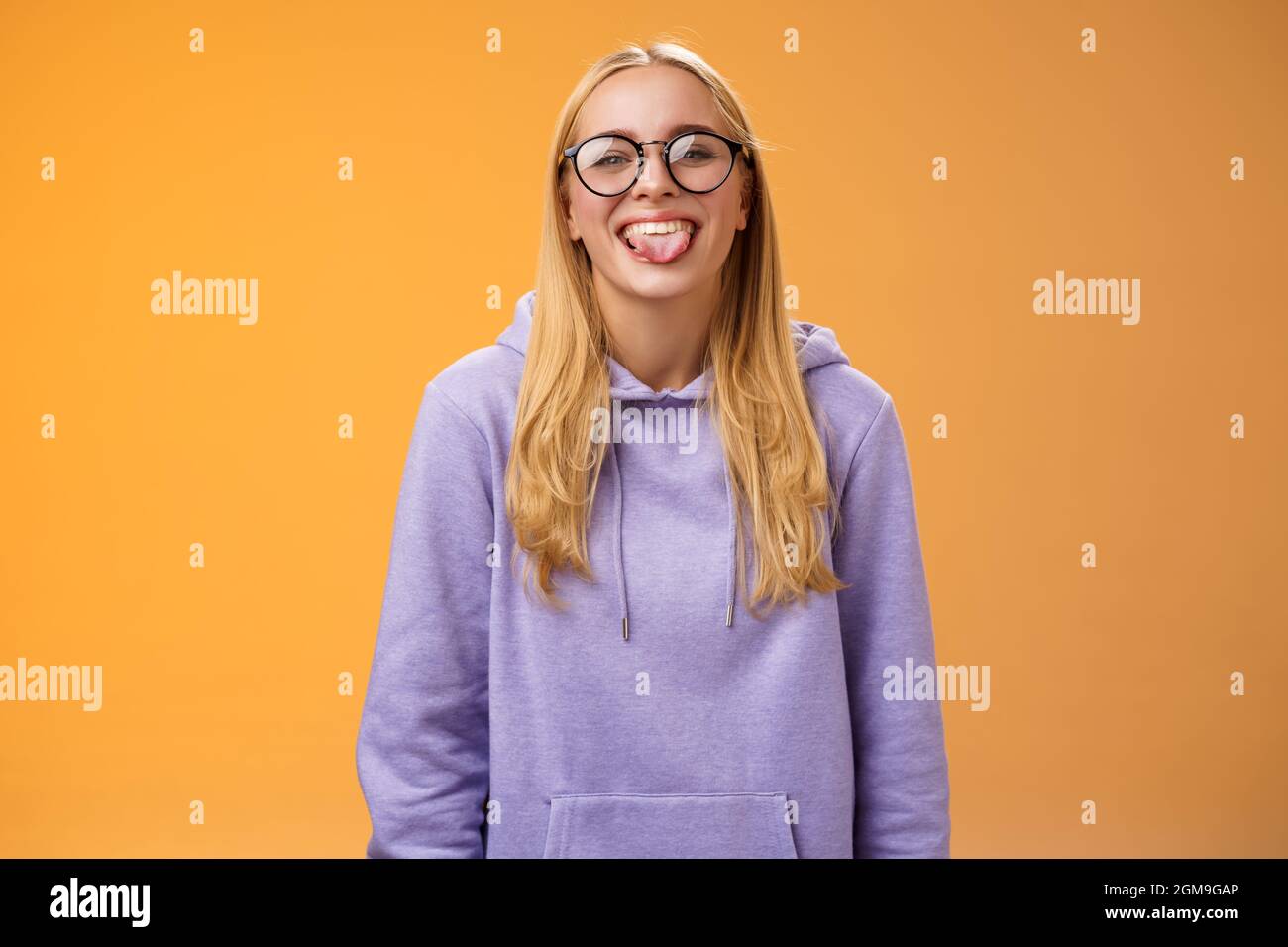 Funny charming female programmer having fun show tongue fool around ...